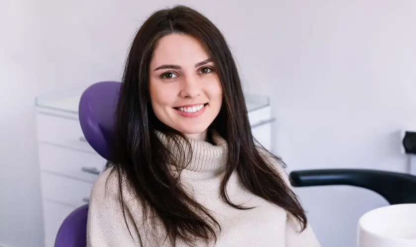 Smiling woman in dental office chair ready for treatment at Castro Valley dentist.