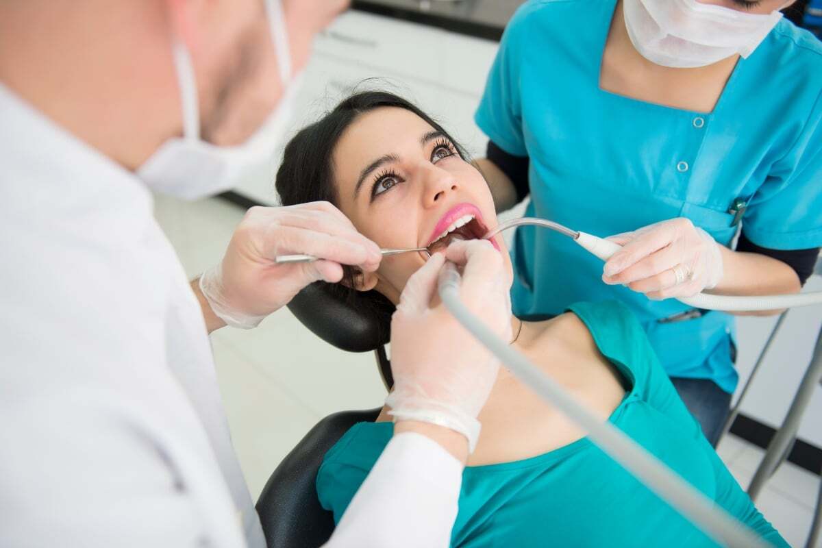 Dentist and assistant examining patient's teeth during dental evaluation in Castro Valley.
