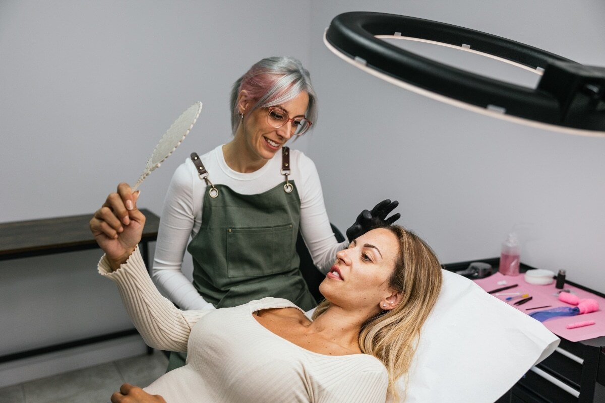 Dental hygienist showing patient a shade guide during preventive cleaning consultation in Castro Valley.