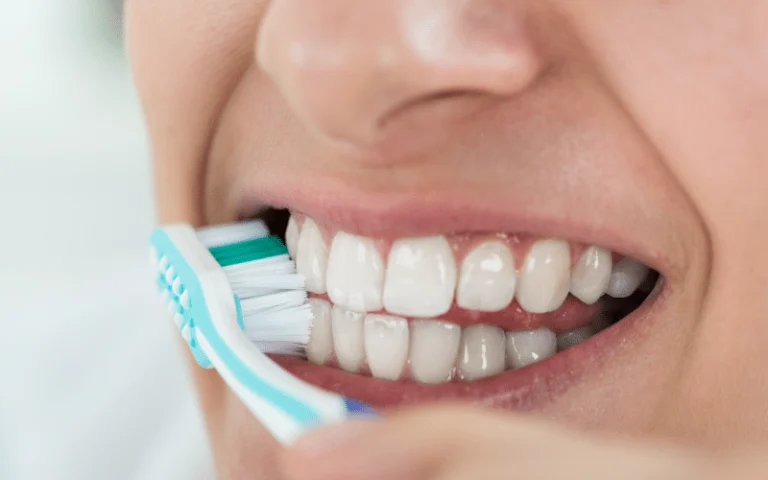 Close-up of a smile while brushing with a toothbrush