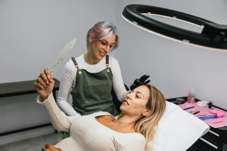 Dental hygienist with a smiling patient in the dental chair